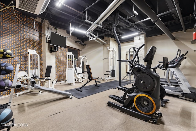 workout area with brick wall