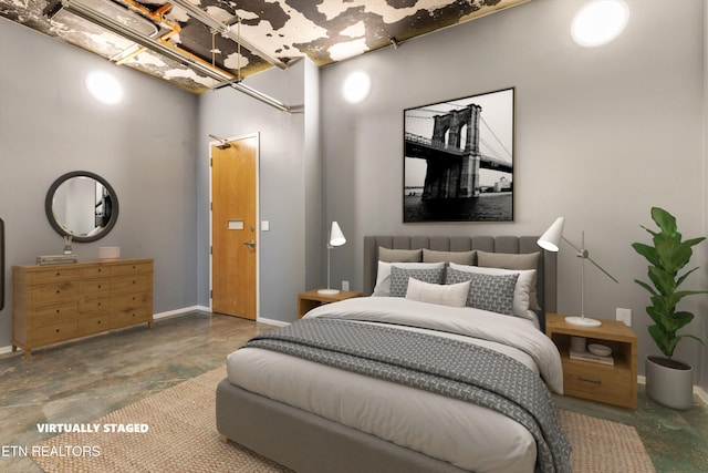 bedroom featuring concrete flooring