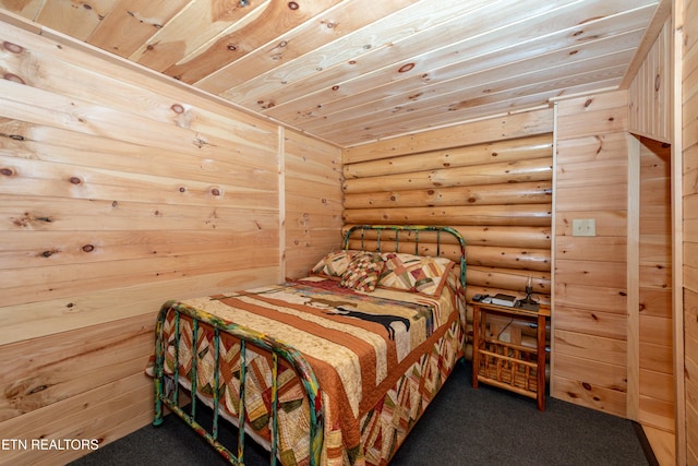 carpeted bedroom with log walls and wooden ceiling