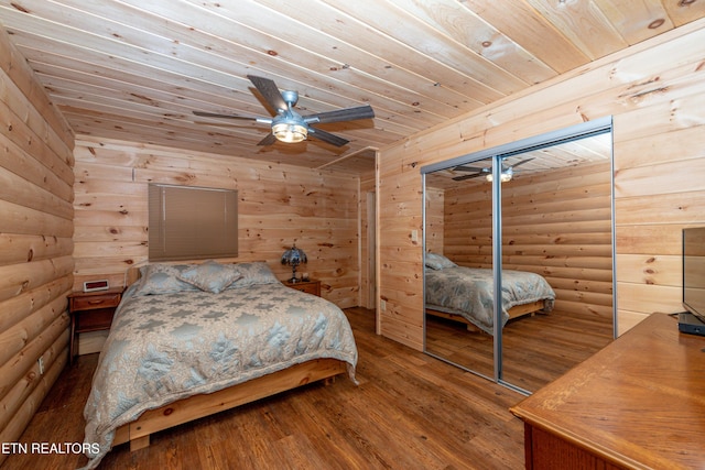 bedroom with rustic walls, ceiling fan, wooden ceiling, hardwood / wood-style floors, and a closet