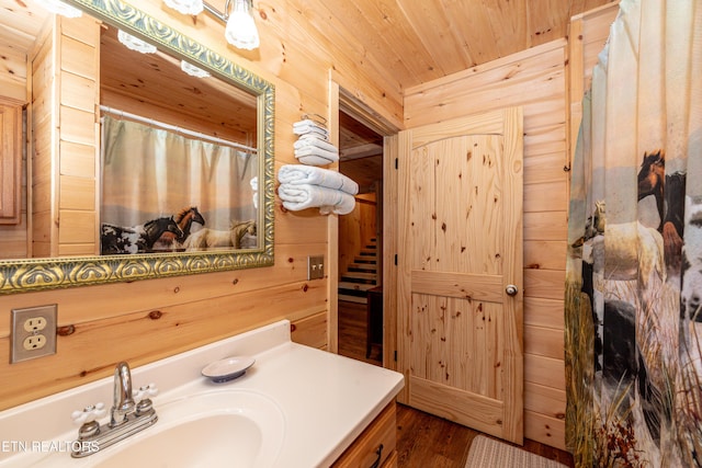 bathroom with vanity, wood walls, and wooden ceiling