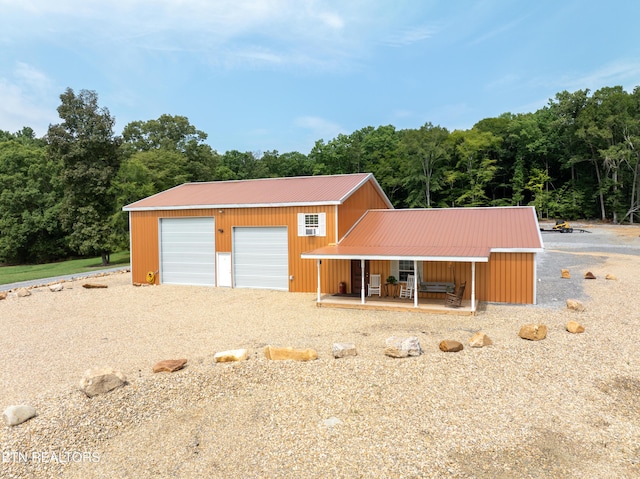 view of outdoor structure featuring a porch and a garage