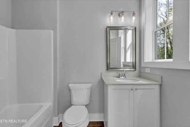 full bathroom featuring bathtub / shower combination, vanity, toilet, and a healthy amount of sunlight