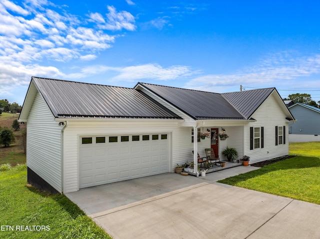 view of front facade with a front yard and a garage