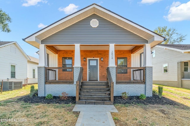 bungalow-style home featuring a porch and central air condition unit