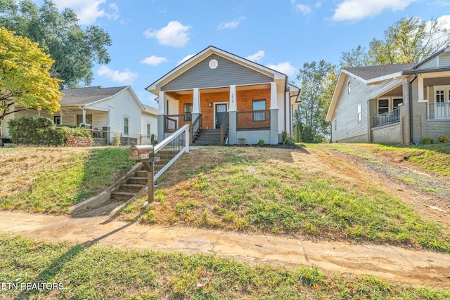 view of front of home featuring a front yard and covered porch