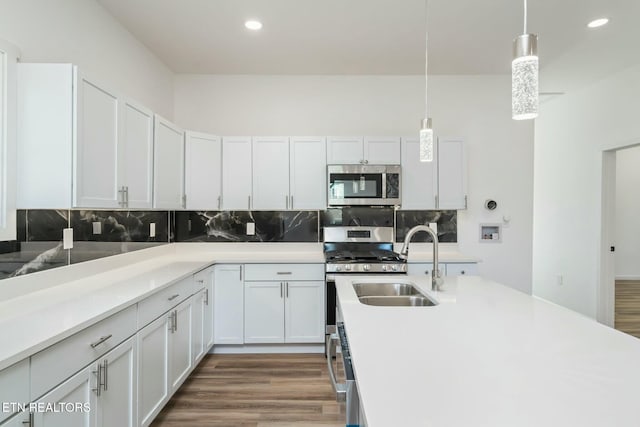 kitchen featuring decorative backsplash, pendant lighting, and white cabinetry