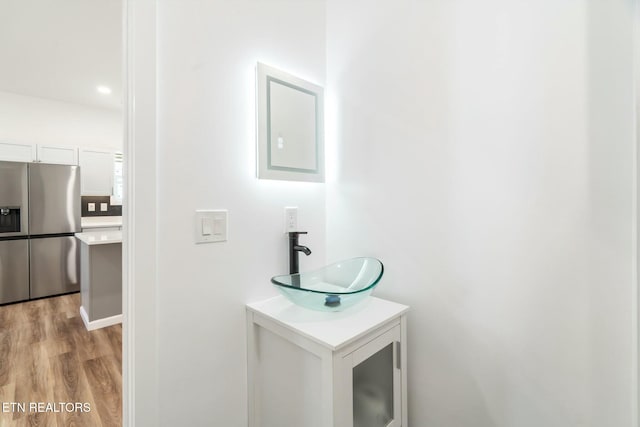 bathroom with hardwood / wood-style floors and vanity