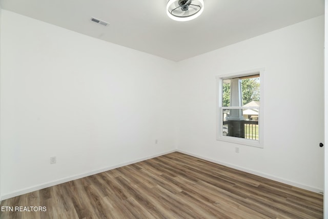 empty room featuring dark wood-type flooring