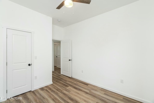 unfurnished bedroom with hardwood / wood-style floors and ceiling fan