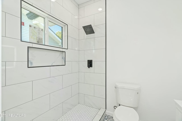 bathroom with toilet and tiled shower