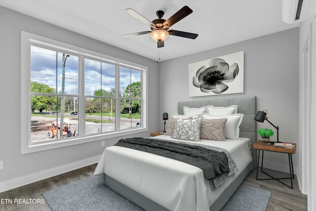 bedroom with hardwood / wood-style flooring and ceiling fan