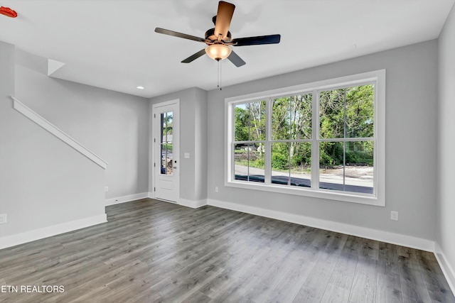 unfurnished living room featuring ceiling fan and wood-type flooring