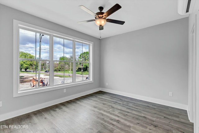 empty room with ceiling fan and dark wood-type flooring