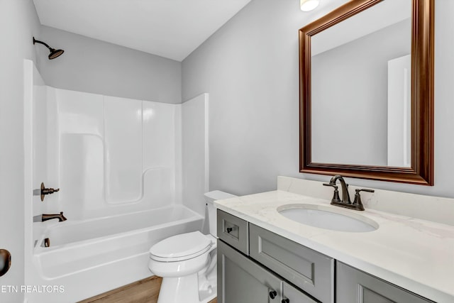 full bathroom with vanity, hardwood / wood-style flooring, toilet, and tub / shower combination