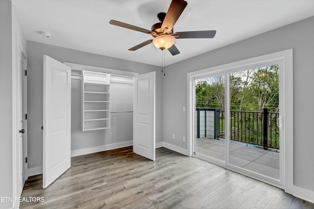 unfurnished bedroom with access to exterior, ceiling fan, a closet, and light hardwood / wood-style flooring