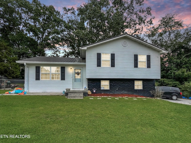 tri-level home featuring a lawn