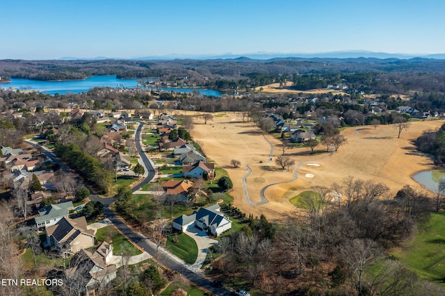 birds eye view of property with a water and mountain view