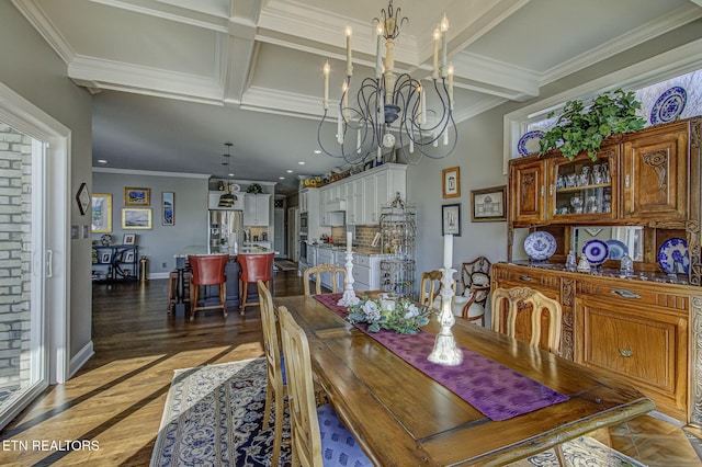 dining space featuring beamed ceiling, ornamental molding, and a notable chandelier