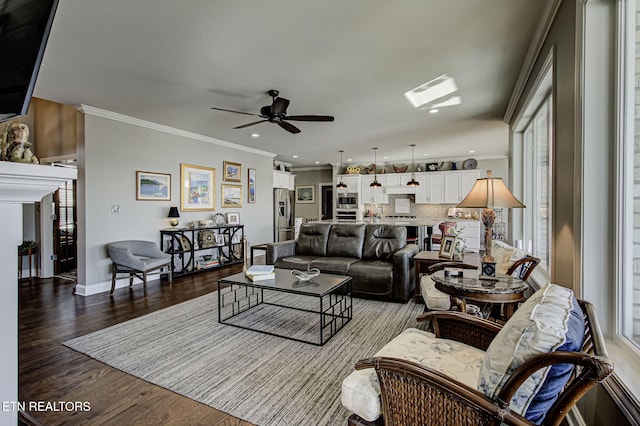 living room featuring ceiling fan, hardwood / wood-style floors, and ornamental molding