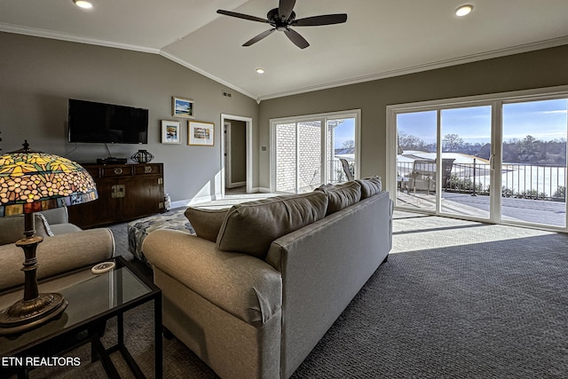 carpeted living room with ceiling fan, crown molding, and vaulted ceiling