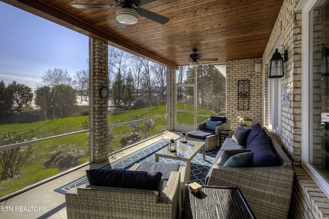 sunroom featuring ceiling fan and wooden ceiling