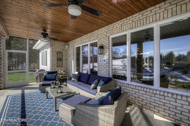 sunroom / solarium featuring ceiling fan