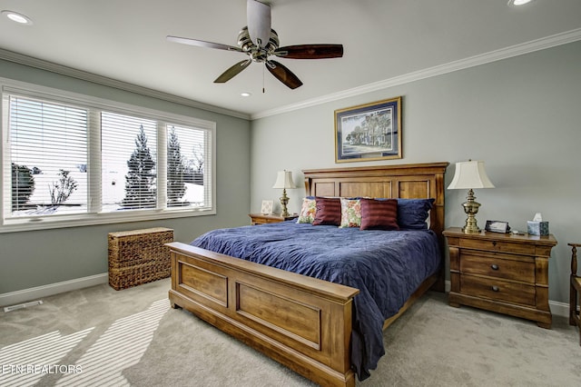 carpeted bedroom featuring ceiling fan and crown molding