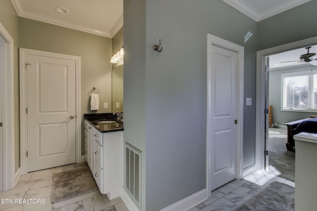 bathroom featuring vanity, ceiling fan, and crown molding