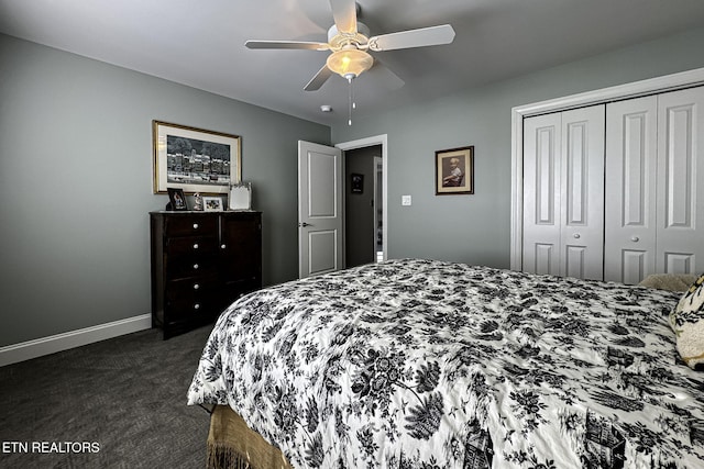 bedroom with dark colored carpet, ceiling fan, and a closet