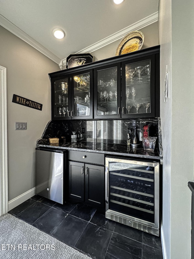 bar featuring refrigerator, wine cooler, ornamental molding, and dark stone countertops