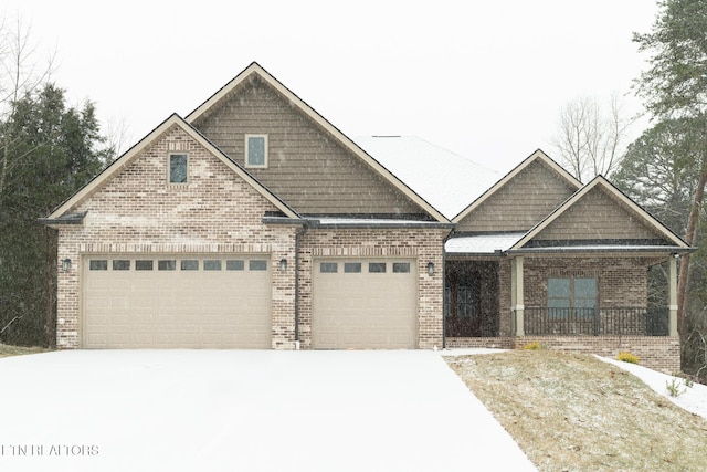 view of front of house featuring a garage, concrete driveway, and brick siding