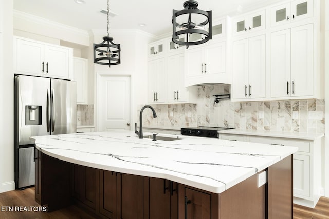 kitchen featuring stainless steel refrigerator with ice dispenser, sink, white cabinets, dark hardwood / wood-style floors, and an island with sink