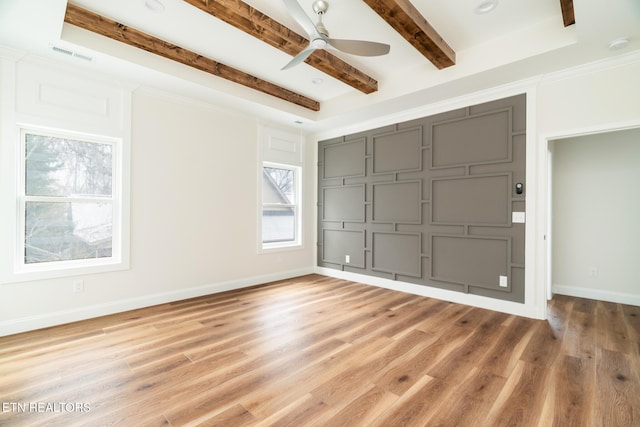 spare room featuring beamed ceiling, wood-type flooring, a raised ceiling, and ceiling fan