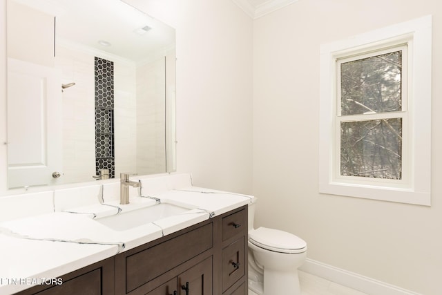 bathroom featuring vanity, toilet, and crown molding