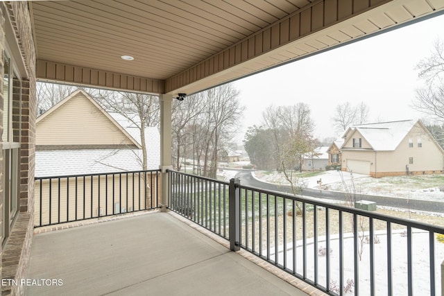 view of snow covered back of property