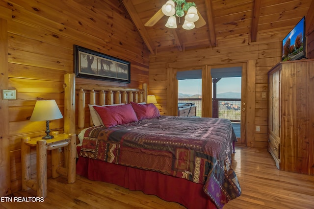 bedroom featuring light hardwood / wood-style floors, lofted ceiling with beams, access to outside, and wood ceiling