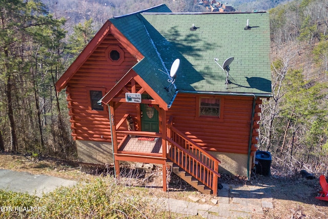 log-style house with central AC unit