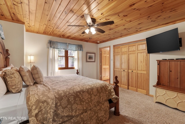 bedroom with wooden ceiling, carpet flooring, ceiling fan, ornamental molding, and a closet