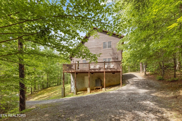 rear view of house featuring a deck