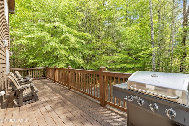 wooden terrace featuring grilling area