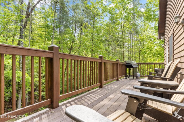 wooden deck featuring area for grilling