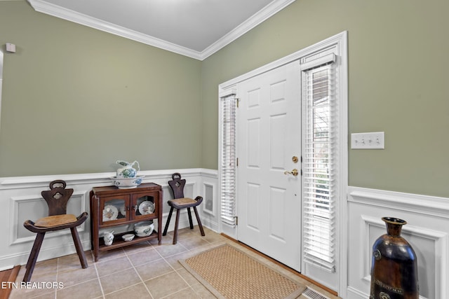 foyer featuring ornamental molding and light tile patterned flooring