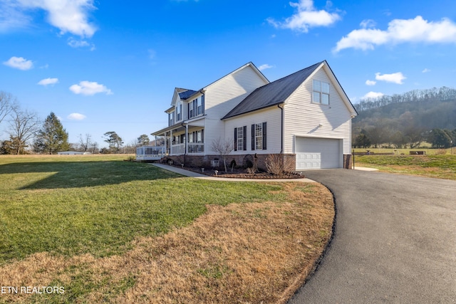 view of property exterior with a garage, a porch, and a lawn