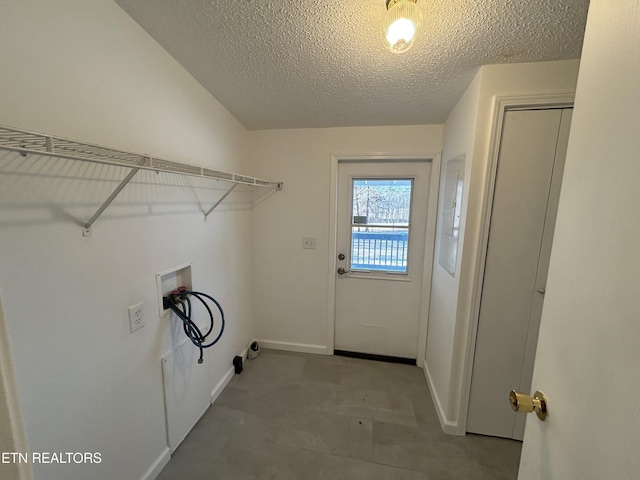 washroom featuring washer hookup and a textured ceiling