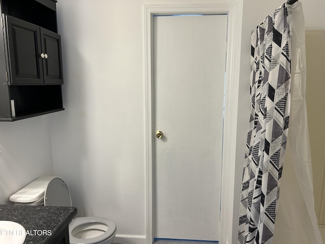 bathroom with vanity, walk in shower, and toilet