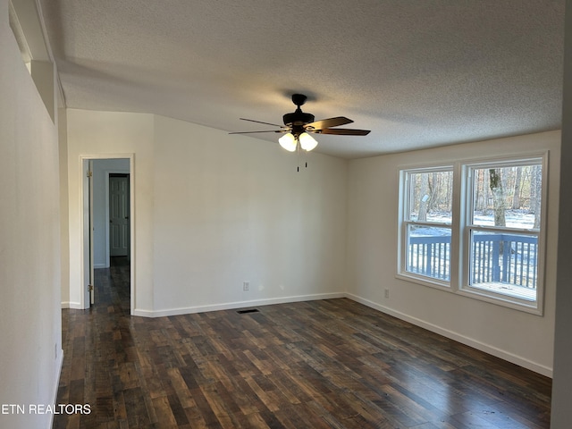 unfurnished room with ceiling fan, dark wood-type flooring, and a textured ceiling