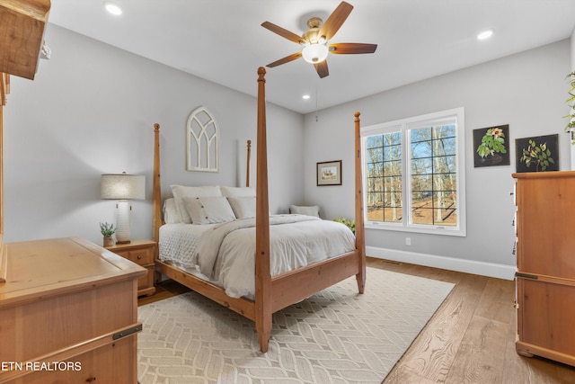 bedroom with ceiling fan and light wood-type flooring