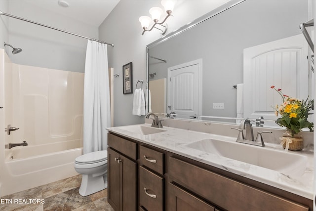 full bathroom featuring toilet, vanity, an inviting chandelier, and shower / bath combination with curtain