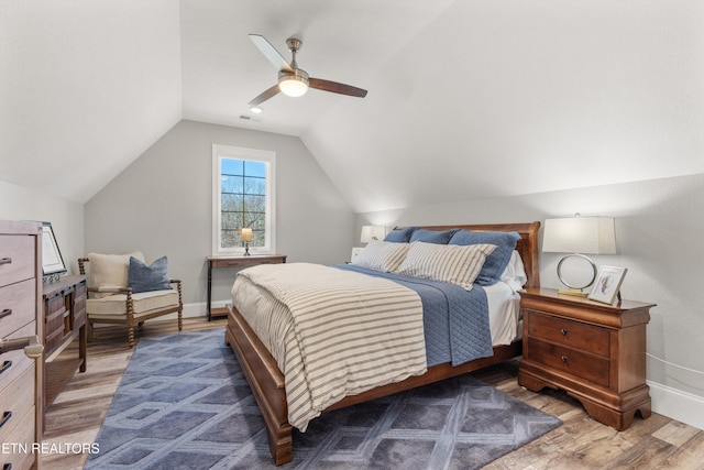 bedroom featuring vaulted ceiling, ceiling fan, and hardwood / wood-style floors